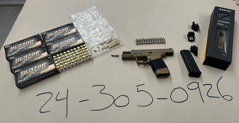 Image of evidence including boxes of ammunition and a handgun